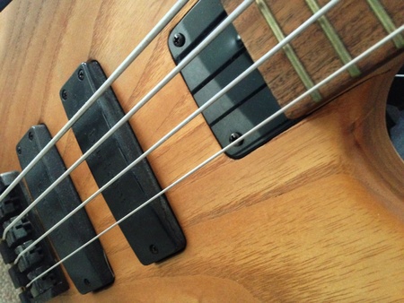 Natural wood bass guitar
