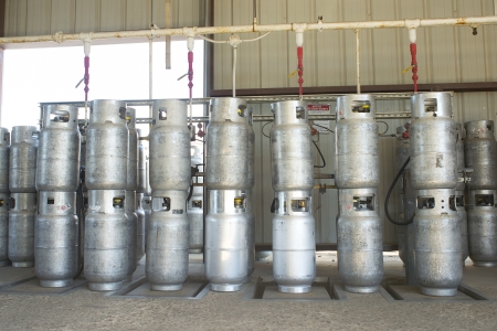Propane cylinders in a warehouse await refillingand transport.
