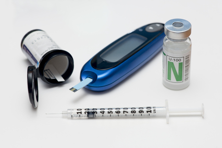 Glucometer, test strips, and NPH insulin with insulin syringeの写真素材