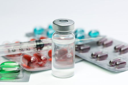 Vial with blank label, syringe and blister packs or medication.の写真素材