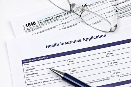 Health insurance application with United States 1040 tax form.の写真素材