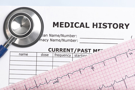 Patient medical history with electrocardiograph and stethoscope.の写真素材