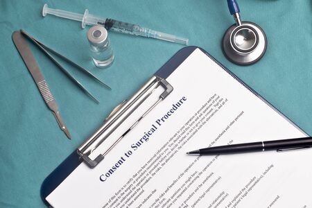 Informed consent for surgical procedure form on surgical table.