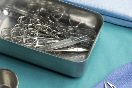 Surgical instruments in tray on operating room table.の写真素材
