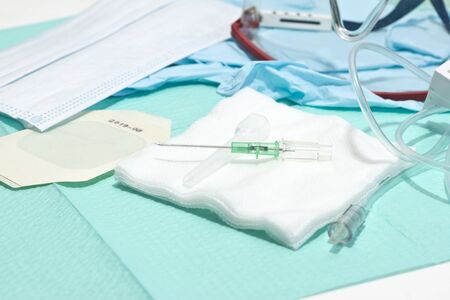 18 gauge IV catheter with mask, gloves, and safety glasses.