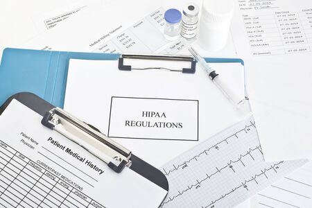 Hipaa regulations manual with patient documents.  All labels and/or documents are fictitious.  Names, serial numbers, and/or dates, are random and any resemblance to actual products is purely cooincidental.の写真素材