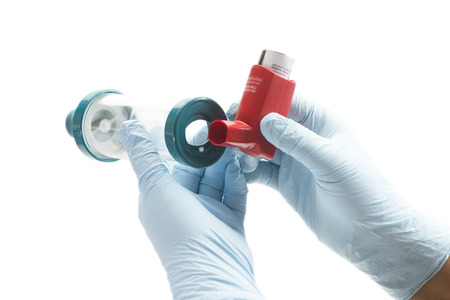 Nurse attaches spacer chamber to asthma inhaler.  Albuterol is a common medication name.