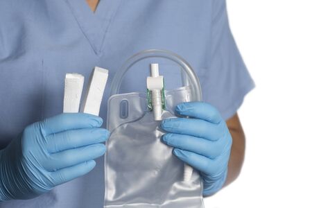 Nurse holds foley catheter leg bag and hook and loop straps