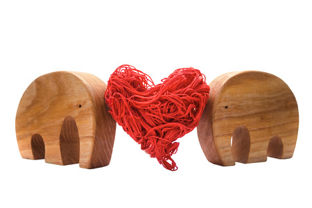 Elephant figurines support together a red decorative heart