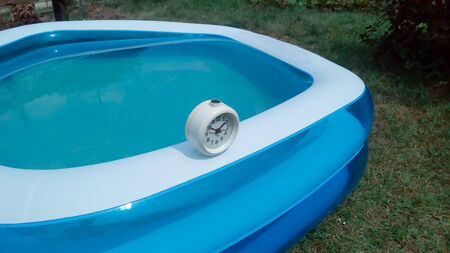 The watch stands on the side of the inflatable pool for organizing swimming time. Time for water...