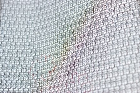 Transparent curtains close-up. A network of weave threads. Beautiful texture pattern of transparent...