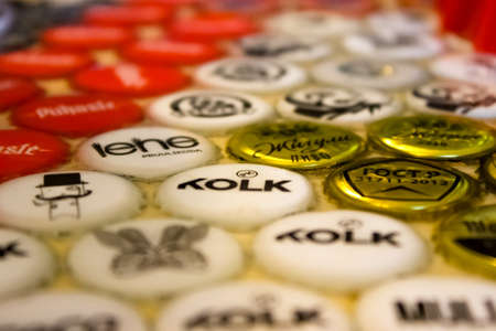 Minsk, Belarus - June 15, 2019: Original surface of the countertop is created from decorative elements and epoxy. Collection of beer caps with different brands of beer is collected at the bar.のeditorial素材