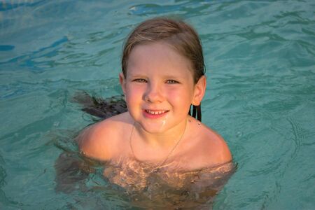 Children have fun with their friends in the water in the pre-fabricated frame pool. Family games in...