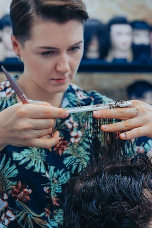 The process of working with the hair of professional barbers clientsの写真素材