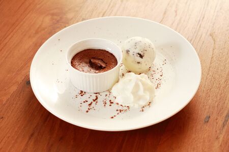 icecream and molten chocolate on white plateの写真素材