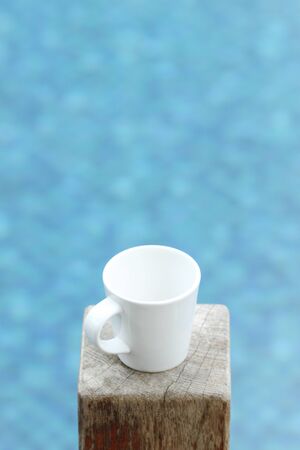 an empty white cup on wood timberの写真素材