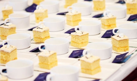 many white cups and  layer cakes for meeting breakの写真素材