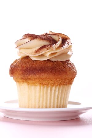 cupcake with swirl icing and white backgroundの写真素材