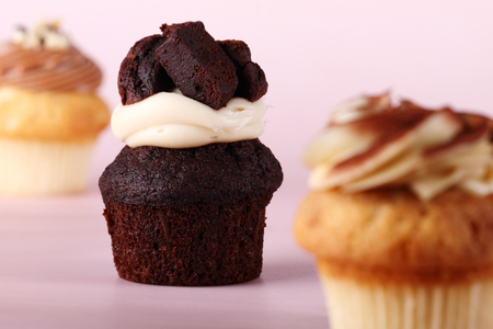 cupcakes with swirl icing and pink background,selective focusの写真素材