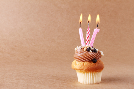 birthday cupcake with candles on backgroundの写真素材