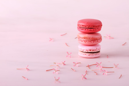 stack of tasty colorful macarons with flowersの写真素材