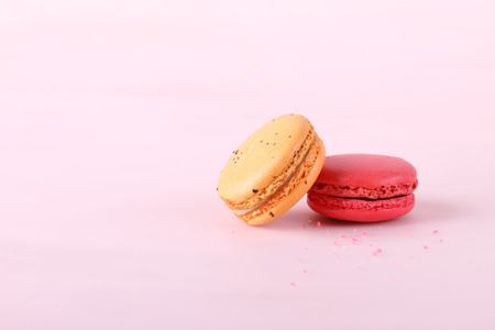 tasty colorful macarons on pink backgroundの写真素材