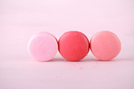 tasty colorful macarons on pink backgroundの写真素材