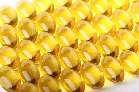 Cod liver oil omega 3 gel capsules line up to a backgroundの写真素材