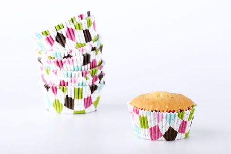 Stack of colorful cupcake cases on white backgroundの写真素材