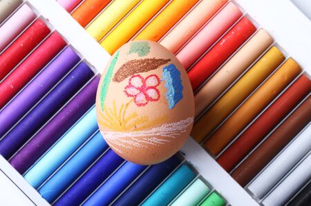Easter egg on colorful pastel wax crayon backgroundの写真素材