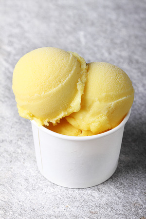 passion fruit sorbet in white cup, close upの写真素材