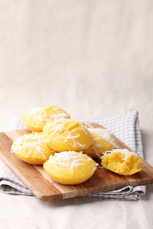 Thai sweet dessert,sugar plam cake with coconut on wooden plateの写真素材
