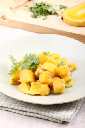 Fresh salad with mango, red shallot, green pepper and pasleyの写真素材