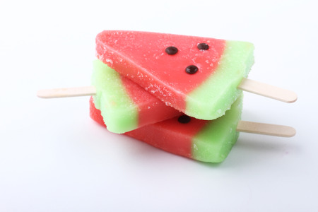 watermelon shaped ice cream pops stack on white backgroundの写真素材