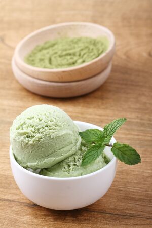 green tea ice cream in white remekin with mintの写真素材