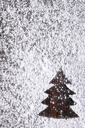 Christmas tree wooden background with snowの写真素材