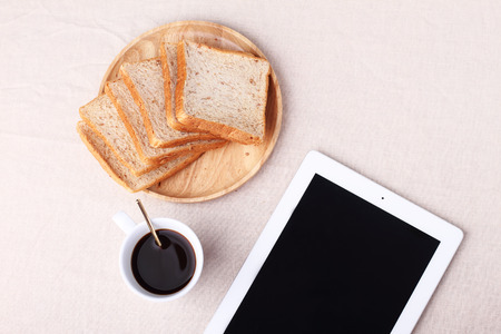 Digital tablet with blank screen with black coffee