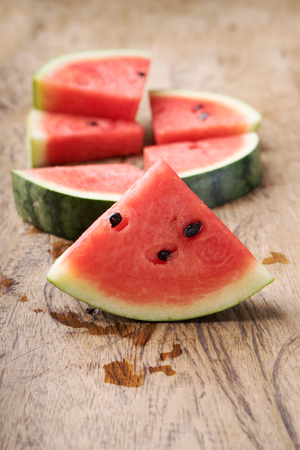 Slices of fresh watermelon on wooden backgroundの写真素材