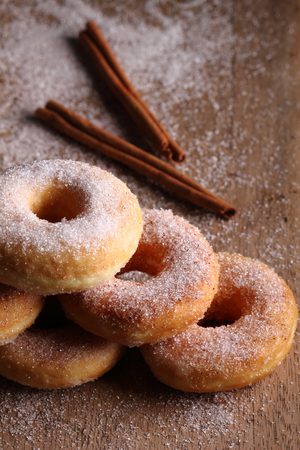 Sweet pieces of sugar doughnuts on wooden backgroundの写真素材
