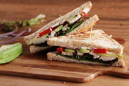 Sandwich of whole wheat bread with chicken and avocadoの写真素材