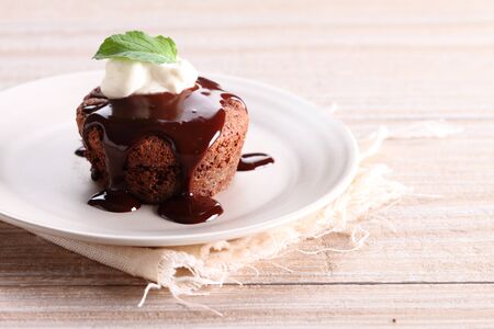 delicious chocolate brownie with fresh cream and chocolate fudge sauceの写真素材