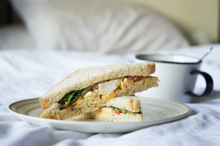 morning egg sandwich breakfast serving on bedの写真素材
