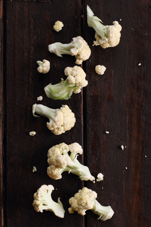fresh cut cauliflower for cooking on rustic wooden backgroundの写真素材