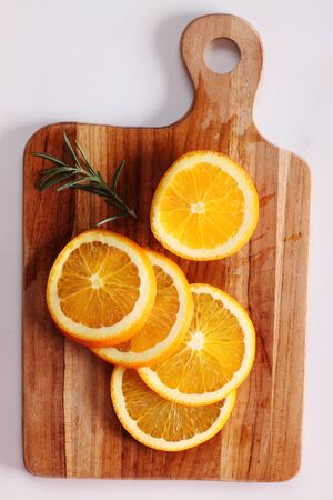 sliced fresh oranges on wooden boardの写真素材