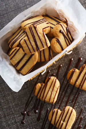 Heart shaped sugar cookies with chocolate sauceの写真素材