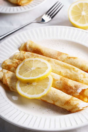 delicious homemade rolled pancakes with fresh lemonの写真素材