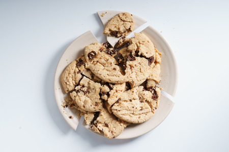 broken plate with chocolate chip cookiesの写真素材