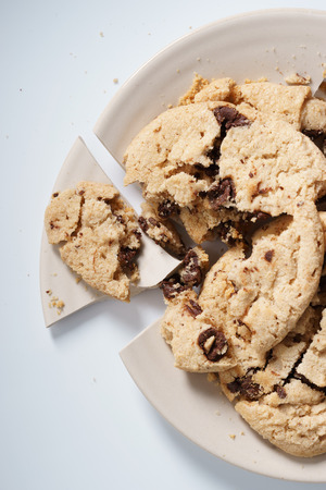 broken plate with chocolate chip cookiesの写真素材