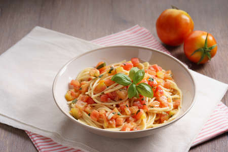 spaghetti with fresh red tomato and basilの写真素材