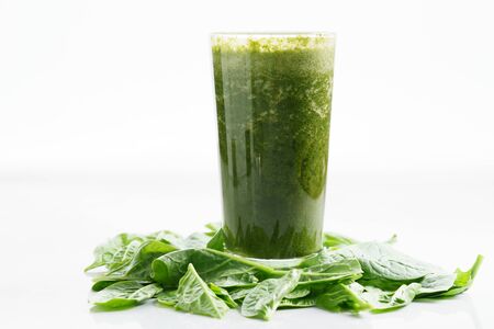 Fresh green juice smoothie made with organic green fruits and vegetablesの写真素材
